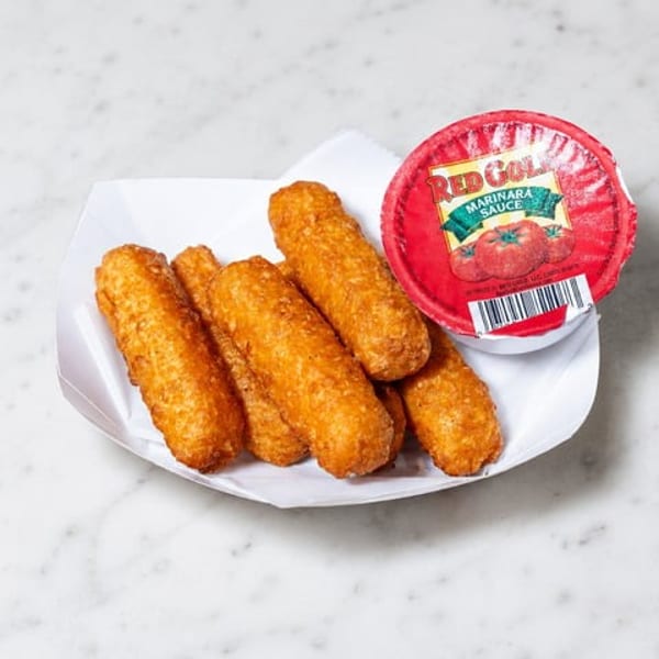 Golden-brown mozzarella sticks in a white tray with a cup of Red Gold marinara sauce.
